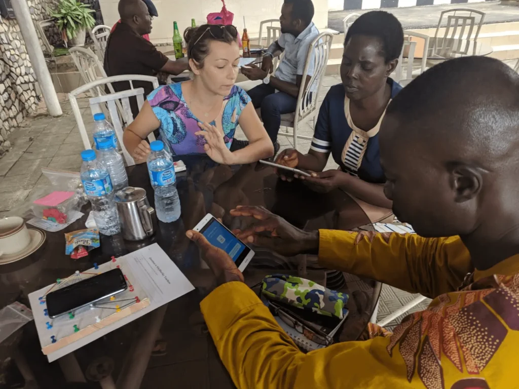 Aga Guzik, one of the WhyBlueSky founders, explaining the WhyBlueSky app. Benin City, 2018.
